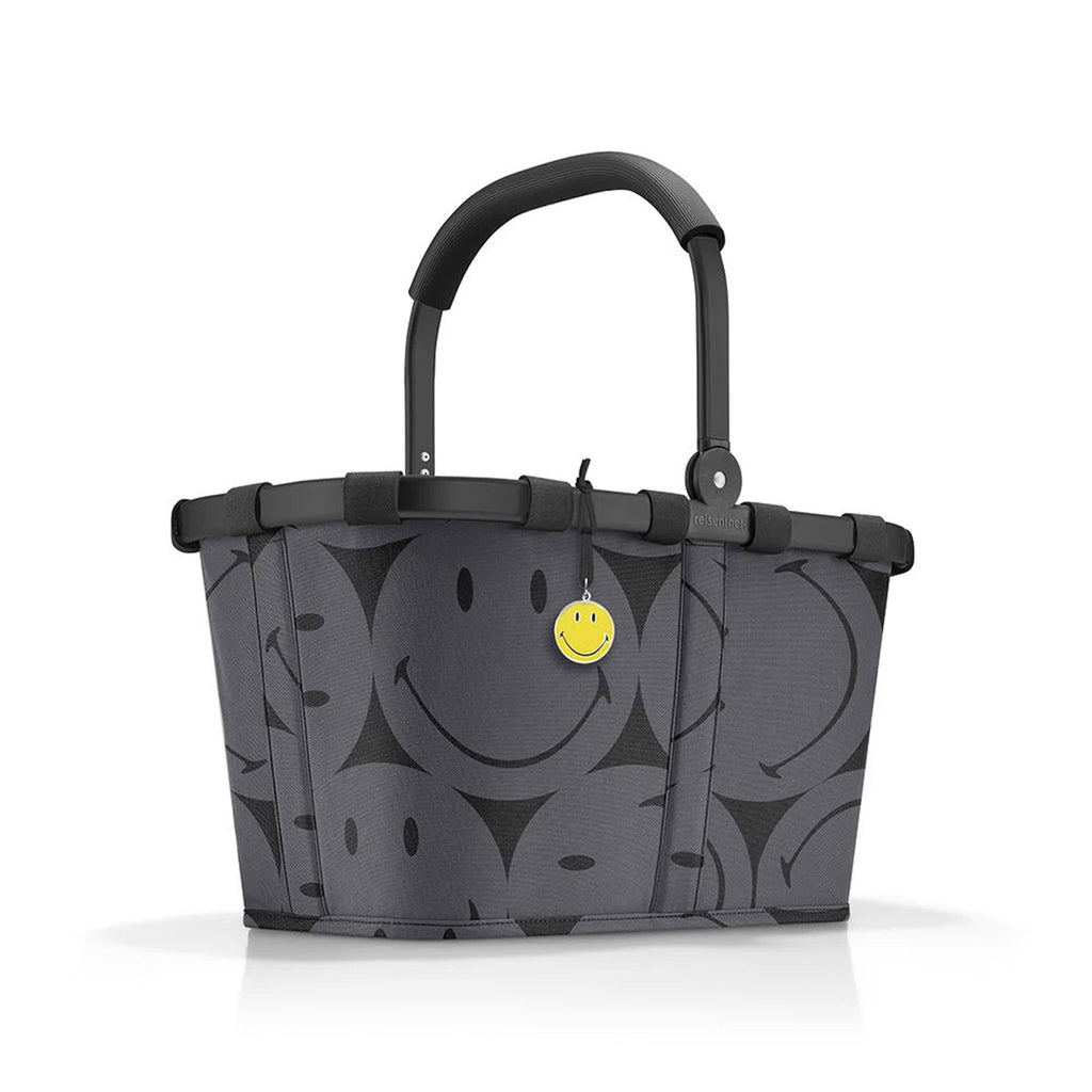 Reisenthel Carrybag Smiley grey in Frontansicht mit Smiley Motiv und gelbem Anhänger
